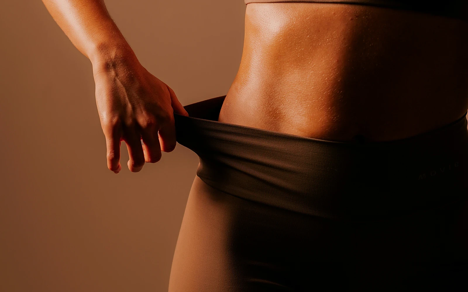 A woman in warm studio light