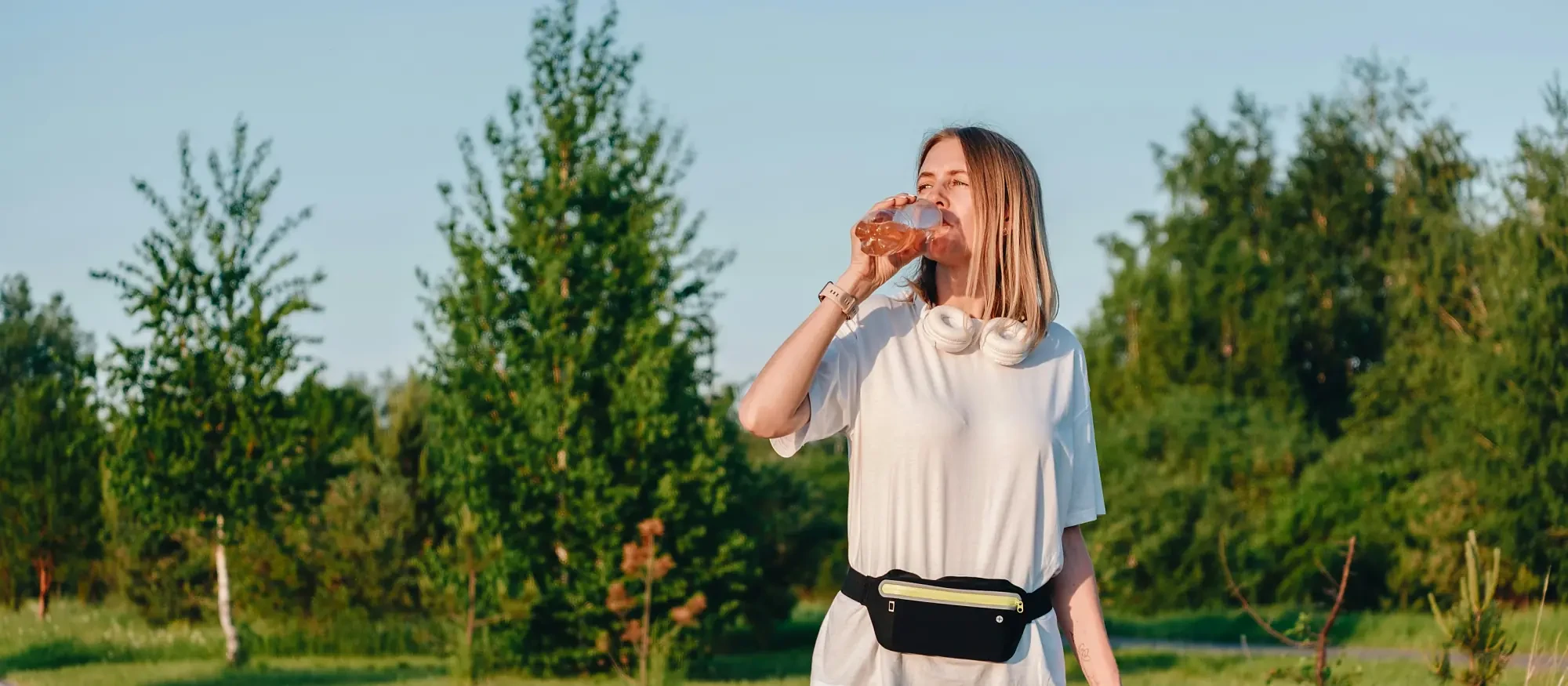 A woman pausing for water on an evening ride
